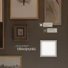 A wall with several framed pictures and a glowing LED panel. Náhled obrázku produktu