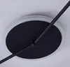 A close-up view of a modern LED ceiling light fixture, showing the central black disc and a portion of the light ring, mounted on a white ceiling. Produktbild-Vorschau
