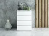 A white dresser with decorative items on top, placed against a concrete wall and a wooden slatted panel. Náhľad obrázku produktu