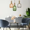 A modern living room scene with three pendant lights hanging above a console table and chairs. Anteprima dell’immagine prodotto