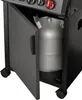 A close-up view of a gas grill's storage compartment, showing a propane tank inside. Produktbild-Vorschau