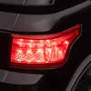 A close-up shot of a red car taillight on a black car. Náhľad obrázku produktu
