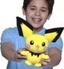 A young boy is holding a Pikachu Pichu plush toy. Anteprima dell’immagine prodotto