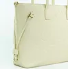 A close-up, studio shot of a cream-colored tote bag with embossed branding. Produktbild-Vorschau