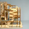 A wooden marble run toy with several marbles visible. Voir les images du produit