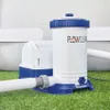 A pool filter pump sits on green artificial grass next to a pool. Voir les images du produit