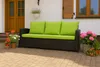 A brown outdoor sofa with bright green cushions sits on a paved patio in front of a house. Anteprima dell’immagine prodotto