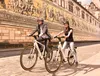 A couple riding electric bikes in front of a mural. Produktbild-Vorschau