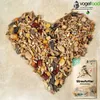A heart shape made of birdseed with a bag of birdseed next to it. Produktbild-Vorschau