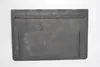 A flat, rectangular, dark gray cast iron plate with raised lines on its surface, placed on a white background. Voir les images du produit