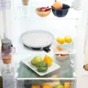 Inside a refrigerator, showing various food items and a cooking pan. Podgląd zdjęcia produktu