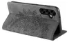 A close-up, angled view of a dark gray flip phone case with an embossed mandala design. Produktbild-Vorschau