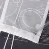 A close-up view of a white fabric curtain with text and circular patterns, layered over a black surface with text. Produktbild-Vorschau