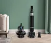 Two vacuum cleaners and accessories are displayed on a wooden floor against a green wall. Anteprima dell’immagine prodotto