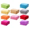 A collection of folded blankets in various colors, neatly stacked. Produktbild-Vorschau