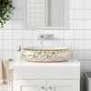 A close-up view of a decorative ceramic vessel sink on a white vanity in a bathroom. Náhled obrázku produktu