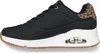 A side view of a black Skechers sneaker with leopard print accents on the heel. Voir les images du produit