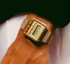 A close-up shot of a gold digital watch on a person's wrist. Podgląd zdjęcia produktu