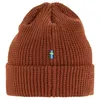 A close-up studio shot of a brown knitted beanie with a small Swedish flag patch on the front. Náhled obrázku produktu