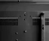 A close-up view of the back of a black electric heater, showing ventilation grilles and mounting points. Náhľad obrázku produktu