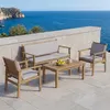 A patio set on a stone patio overlooking the ocean. Voir les images du produit