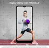 A woman holding a purple ball is displayed on a smartphone screen, set against a concrete wall background. Podgląd zdjęcia produktu