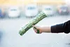 A hand holding a green and white cleaning tool, wiping a window with soap suds. Náhľad obrázku produktu