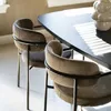 Two upholstered dining chairs are placed next to a dark dining table, with sunlight streaming through blinds. Produktbild-Vorschau