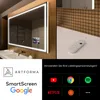 A smart bathroom mirror with integrated LED lighting and a small screen displaying app icons, shown with a remote control on a countertop. Produktbild-Vorschau