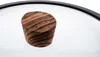 A close-up shot of a wooden knob on a glass lid of a pot or pan. Produktbild-Vorschau