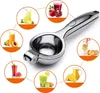 A manual citrus juicer is shown in the center, surrounded by circular images of various fruits and juices. Produktbild-Vorschau