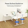 A white L-shaped standing desk with monitors and accessories, set against a light gray wall and wooden floor. Náhled obrázku produktu