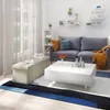 A living room scene with a sofa, coffee table, ottoman, and shelves. Náhľad obrázku produktu