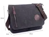 A dark gray canvas messenger bag with brown leather accents and a brown strap is shown against a white background. Dimensions are indicated with measurement lines and text. Podgląd zdjęcia produktu