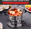 A stainless steel stove and pot filled with food, placed on a dark countertop. Podgląd zdjęcia produktu