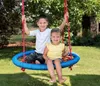 Two children are sitting on a blue net swing under a tree. Produktbild-Vorschau