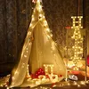 A decorated tent with fairy lights and marquee letters spelling out 'HAPPY' and 'U'. Anteprima dell’immagine prodotto