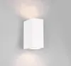 A white, rectangular wall light fixture mounted on a light gray wall, emitting light upwards and downwards. Produktbild-Vorschau