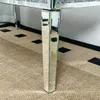 A close-up view of the mirrored legs of a glass table. Anteprima dell’immagine prodotto
