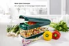 A Nicer Dicer Exclusive vegetable chopper is shown with chopped vegetables inside and various fresh vegetables around it. Anteprima dell’immagine prodotto