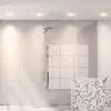 A modern bathroom with a glass-enclosed shower, featuring a shower head and a mosaic tiled vanity. Produktbild-Vorschau