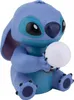 A blue Stitch figurine holding a white orb. Produktbild-Vorschau