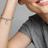 A close-up shot of a person's arm wearing a Pandora bracelet with a heart-shaped charm. Anteprima dell’immagine prodotto
