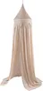 A beige mosquito net hanging from a single point. Produktbild-Vorschau