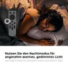 A woman sleeping in bed with a remote control in the foreground. Produktbild-Vorschau
