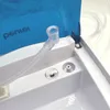 A close-up view of a nebulizer with a blue lid and a clear tube. Produktbild-Vorschau