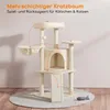 A beige multi-level cat tree with various platforms, a hideaway cave, and scratching surfaces, shown on a light gray rug with a toy fish on the floor. Orange dashed lines connect different parts of the cat tree, indicating features or play areas. Podgląd zdjęcia produktu