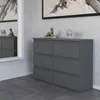 A modern gray dresser with six drawers is shown in a well-lit room with textured walls and a large mirror reflecting a portion of the dresser and its surroundings. Náhľad obrázku produktu