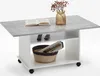 A coffee table with storage, featuring a faux concrete top and a basket for magazines. Produktbild-Vorschau