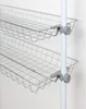 Close-up of two wire storage baskets attached to a white pole. Produktbild-Vorschau